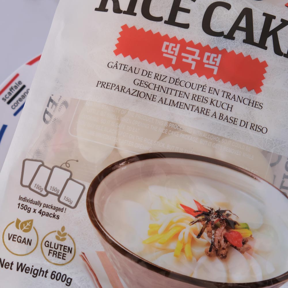 Gnocchi di riso coreani affettati con sfondo marmo e piatto di Scaffale Coreano