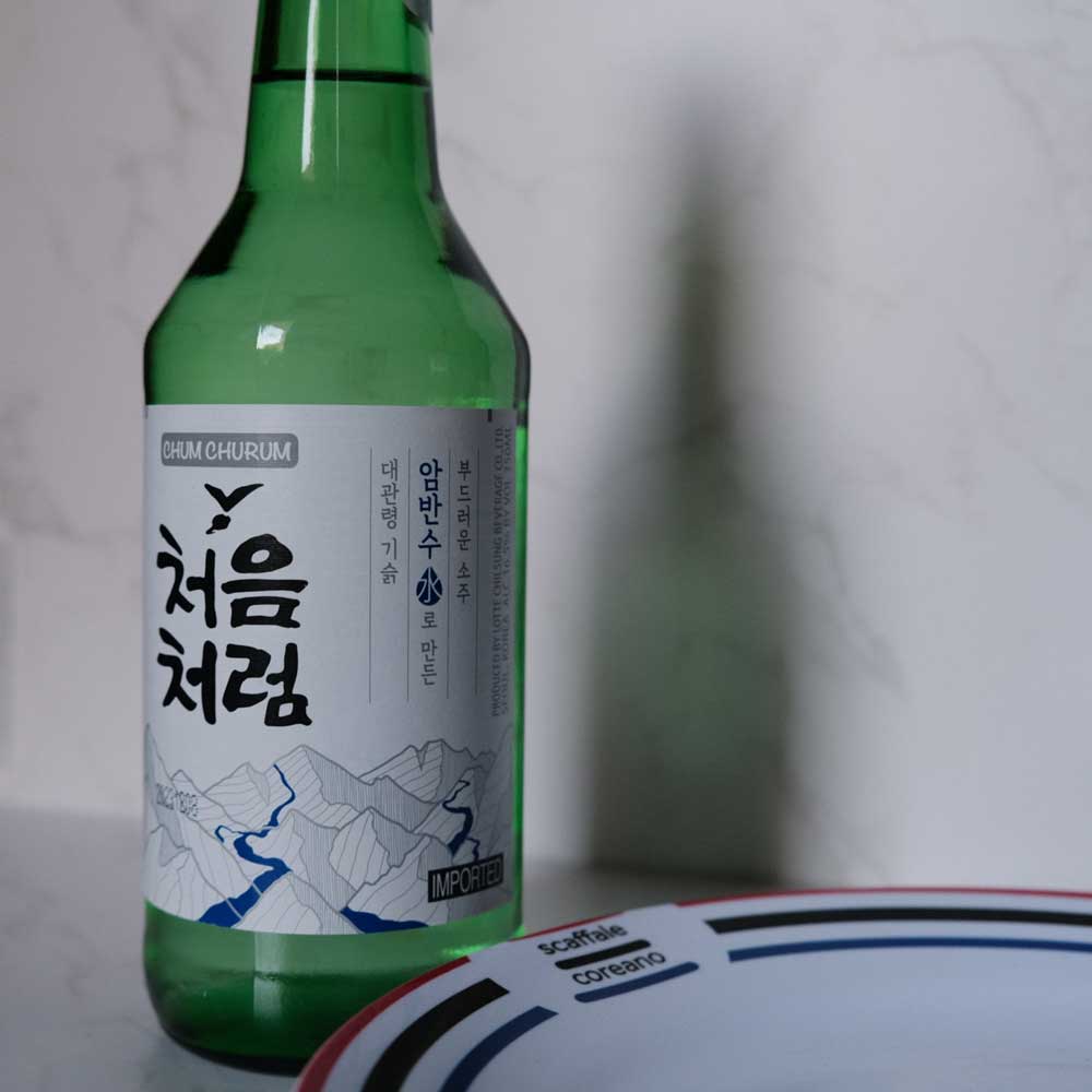 Bottiglia di Soju Originale con sfondo marmo e piatto di Scaffale Coreano