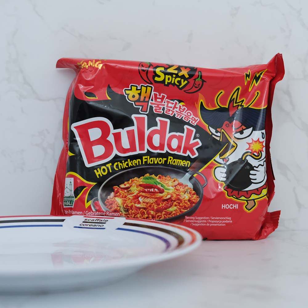 Hot Chicken Buldak X2 doppia piccantezza di Samyang con sfondo marmo e piatto di Scaffale Coreano